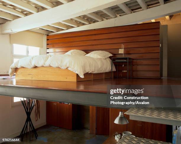 View of a cozy bed in an eclectic bedroom.