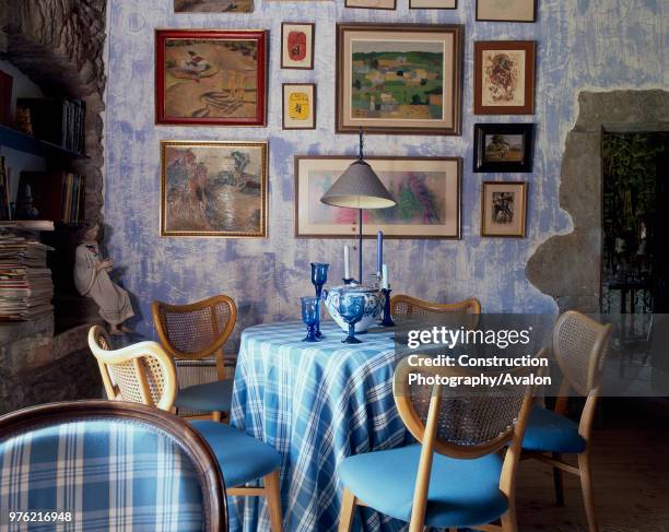 View of a cozy dining area adorned with paintings.