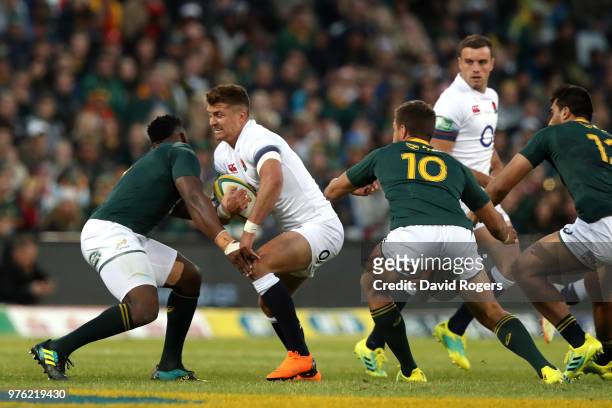 Henry Slade of England prepares to get tackled by South Africa's Franco Mostert during the second test match between South Africa and England on June...