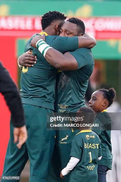 South Africa's flanker and captain Siya Kolisi hugs South Africa's prop Tendai Mtawarira, who today earns his 100th cap for the Springboks, as...