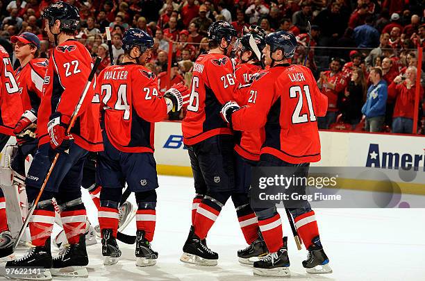 Tomas Fleischmann of the Washington Capitals celebrates with teammates after scoring the game winning goal in overtime against the Carolina...