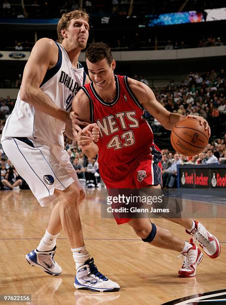 Kris Humphries of the New Jersey Nets drives against Dirk Nowitzki of the Dallas Mavericks during a game at the American Airlines Center on March 10,...