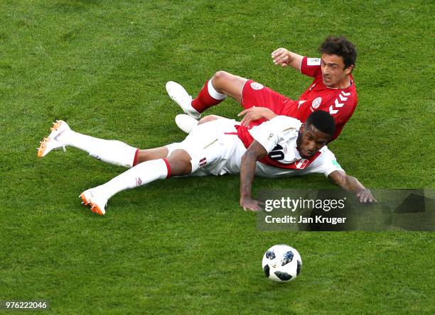 Jefferson Farfan of Peru and Thomas Delaney of Denmark fall down during the 2018 FIFA World Cup Russia group C match between Peru and Denmark at...