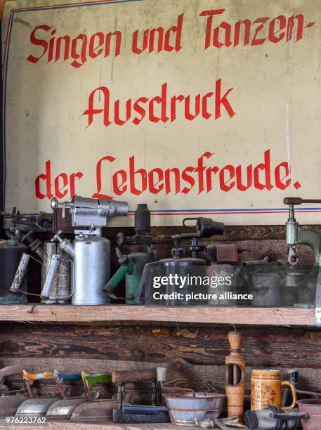 June 2018, Germany, Philadelphia: A sign from GDR times with the inscription 'Singing and dancing - expression of joie de vivre' hanging over a...