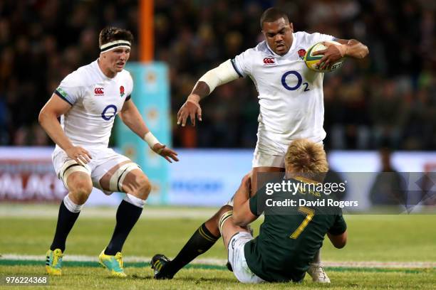 Kyle Sinckler of England is tackled by South Africa's Pieter-Steph du Toit during the second test match between South Africa and England on June 16,...