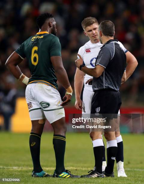 Referee Romain Poite of France issues a warning for fighting to both team captains, Owen Farrell of England and Siya Kolisi of South Africa during...