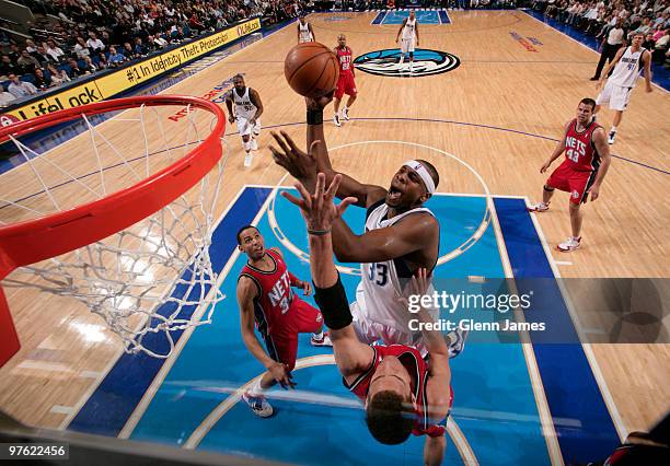 Brendan Haywood of the Dallas Mavericks goes up for the layup against Kris Humphries of the New Jersey Nets during a game at the American Airlines...