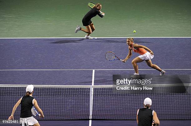 Shahar Pe'er of Israel and Sara Errani of Italy compete in their match against Cara Black of Zimbabwe and Liezel Huber of the United States during...