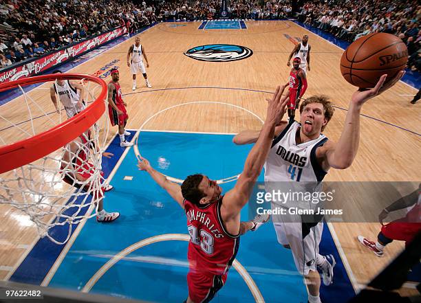 Dirk Nowitzki of the Dallas Mavericks goes up for the layup against Kris Humphries of the New Jersey Nets during a game at the American Airlines...