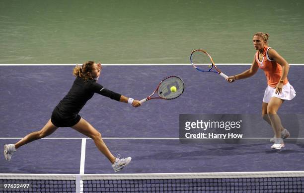 Shahar Pe'er of Israel stretches for a volley in front of Sara Errani of Italy in their match against Cara Black of Zimbabwe and Liezel Huber of the...