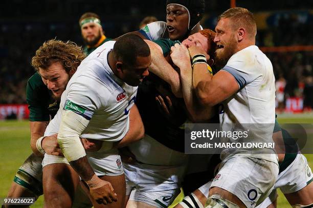 South Africa's loose head prop Steven Kitshoff is caught between England's tight head prop Kyle Sinckler and England's flanker Brad Shields during...