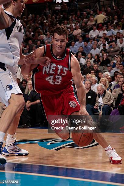 Kris Humphries of the New Jersey Nets drives against Dirk Nowitzki of the Dallas Mavericks during a game at the American Airlines Center on March 10,...