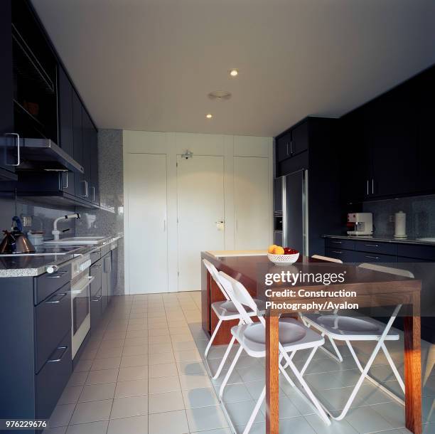 View of a wooden dining table in an elegant kitchen.