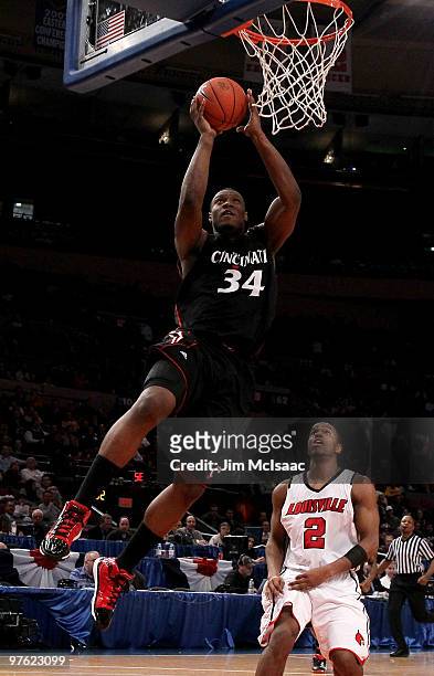 Yancy Gates of the Cincinnati Bearcats goes to the hoop against Preston Knowles of the Louisville Cardinals during the second round of 2010 NCAA Big...