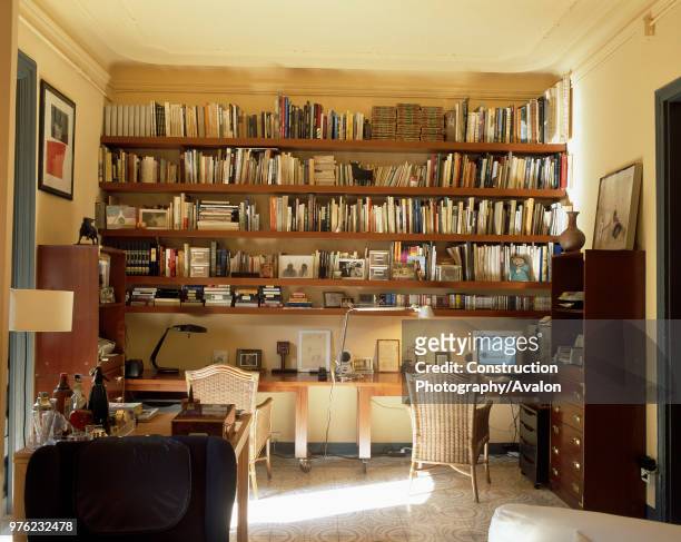 View of well stocked bookshelves in a home office.
