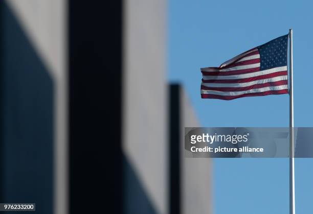 June 2018, Germany, Berlin: The flag of the United States of America blowing on the roof of the US Embassy. The new US ambassador and Trump...