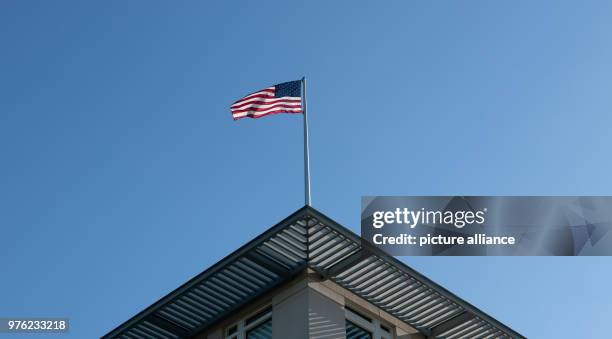 June 2018, Germany, Berlin: The flag of the United States of America blowing on the roof of the US Embassy. The new US ambassador and Trump...