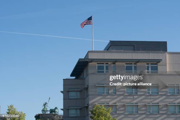 June 2018, Germany, Berlin: The flag of the United States of America blowing on the roof of the US Embassy. The new US ambassador and Trump...