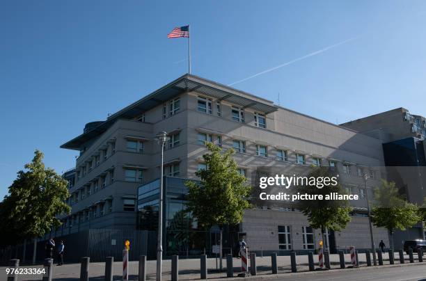 June 2018, Germany, Berlin: The flag of the United States of America blowing on the roof of the US Embassy. The new US ambassador and Trump...