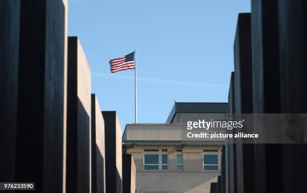 June 2018, Germany, Berlin: The flag of the United States of America blowing on the roof of the US Embassy. The new US ambassador and Trump...
