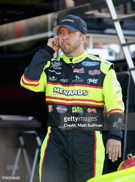 Matt Crafton, driver of the Jack Links/Menards Ford, walks to his truck during practice for the NASCAR Camping World Truck Series M&M's 200 at Iowa...