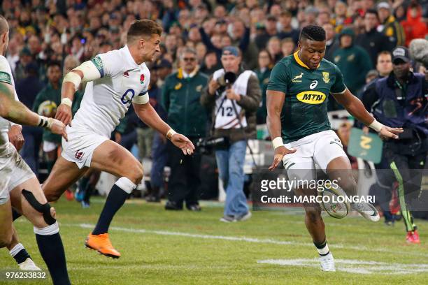 South Africa's wing S'busiso Nkosi kicks the ball forward during the second test match South Africa vs England at the Free State Stadium in...