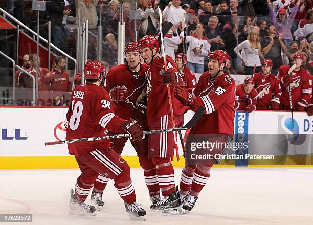 Taylor Pyatt of the Phoenix Coyotes celebrates with teammates Vernon Fiddler, Zbynek Michalek and Ed Jovanovski after Pyatt scored a second period...