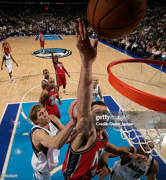 Kris Humphries of the New Jersey Nets goes in for the tip in against Dirk Nowitzki of the Dallas Mavericks during a game at the American Airlines...