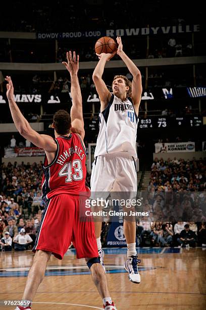 Dirk Nowitzki of the Dallas Mavericks shoots a jumper against Kris Humphries of the New Jersey Nets during a game at the American Airlines Center on...