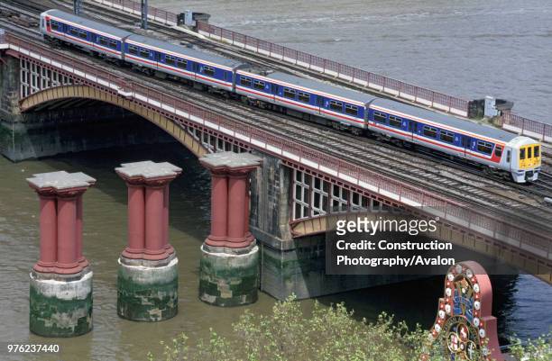 Blackfriars Bridge, London, with a Thameslink Class 319/1 EMU in Network SouthEast livery crossing with a Brighton service, circa 1993.