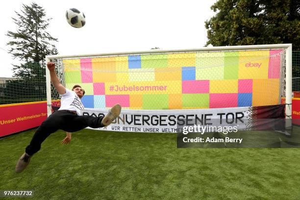 An employee kicks a ball into the goal used by the German national football team in the match in which it won the 2014 World Cup against Argentina,...