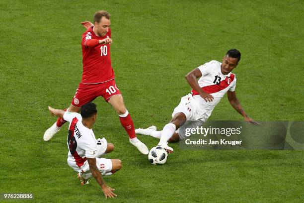 Yoshimar Yotun and Renato Tapia of Peru challenge Christian Eriksen of Denmark during the 2018 FIFA World Cup Russia group C match between Peru and...