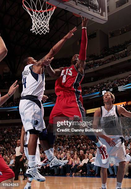 Terrence Williams of the New Jersey Nets goes up for the layup against Caron Butler of the Dallas Mavericks during a game at the American Airlines...