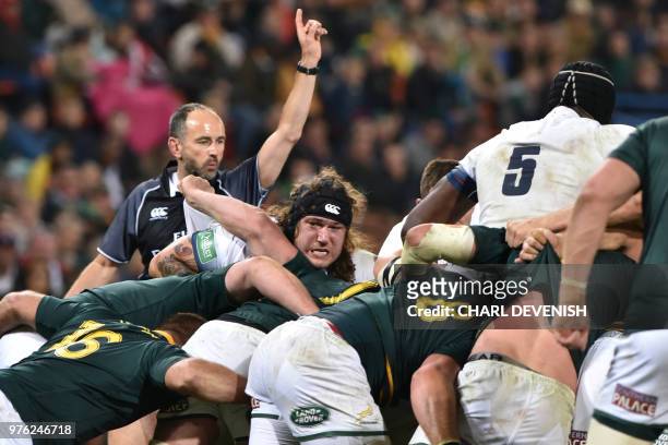 Englands prop Harry Williams pushes during a scrum as French referee Romain Poite signals a foul during the second test match South Africa vs England...