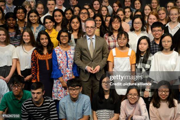 June 2018, Germany, Berlin: Minister for Foreign Affairs from the Social Democratic Party , Heiko Maas, standing with school pupils that take part in...