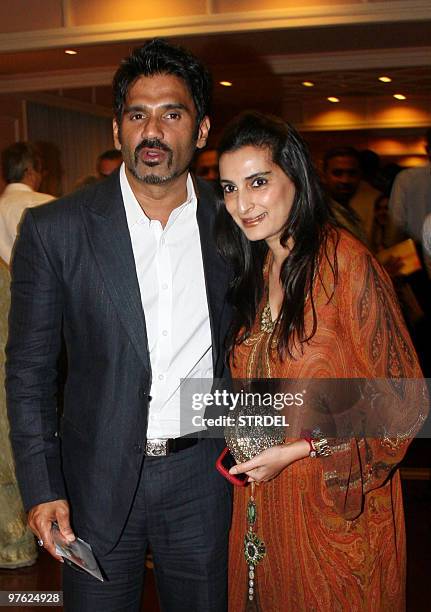 Indian actor Suniel Shetty poses with his wife at an awards ceremony in Mumbai late March 10, 2010. AFP PHOTO/STR