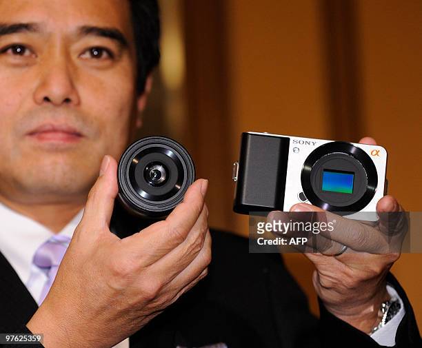Sony senior vice president Masashi Imamura displays a prototype model of an ultra compact interchangeable lens digital camera with an APS-C sized...