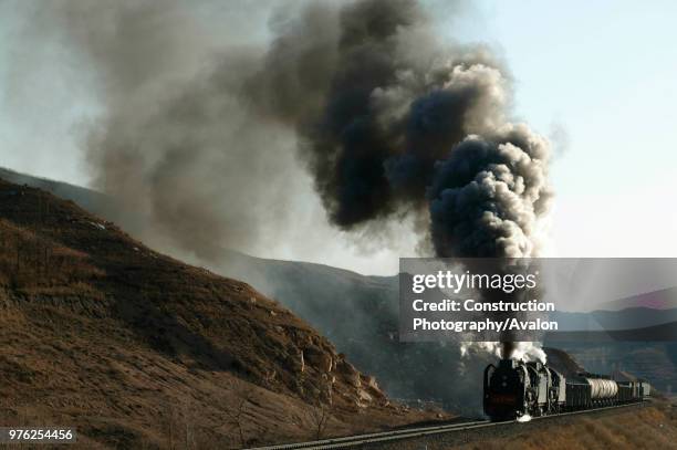 The magic of Chinas Jing Peng pass is revealed here as two QJs haul a Holoku to Daban freight over the tortuous grades to the summit at Shangdian,...