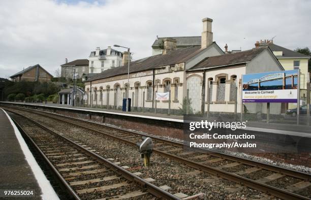 View of the platforms at Saltash station, Cornwall, showing the old station building and one of the Welcome to Cornwall signs 12th April 2006.