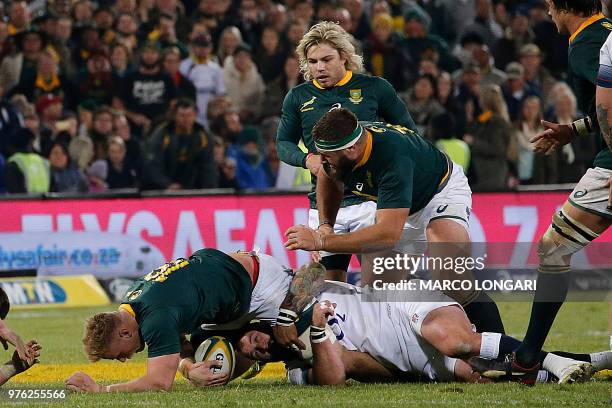 South Africa's flanker Jean-Luc du Preez is tackled by England's prop Joe Marler during the second test match between South Africa and England at the...