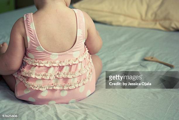 baby girl in a ruffly pink bathing suit - elmore stock pictures, royalty-free photos & images