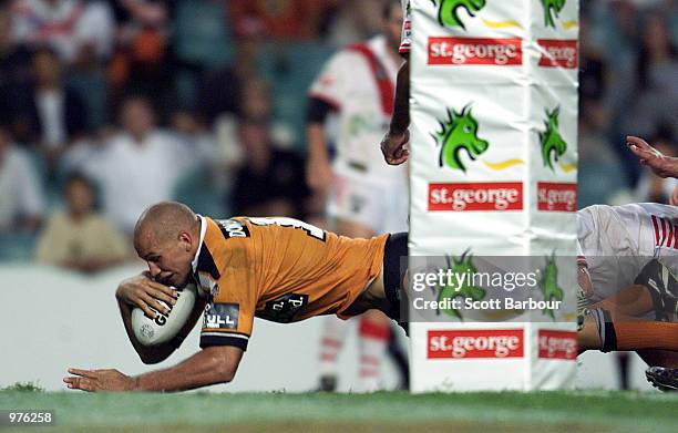 Tyran Smith of the Tigers scores the winning try during the round 2 NRL match between the St George Illawarra Dragons and Wests Tigers played at the...