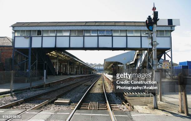 View of the station, footbridge and semaphore signalling at Truro station, Cornwall, from the level crossing at the end of then platform 5th April...