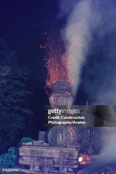 Colouring the night sky with fire. Wood burning Shay No 10 of the Insular Lumber Company on the Philippine island of Negros shuffles along between...