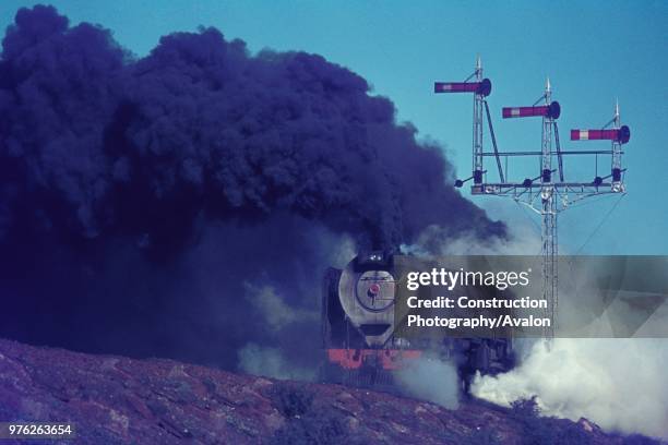 South African Railways condenser 25 Class 4-8-4 at work between Hutchinson and Three Sisters in the Karroo Desert in June 1973.