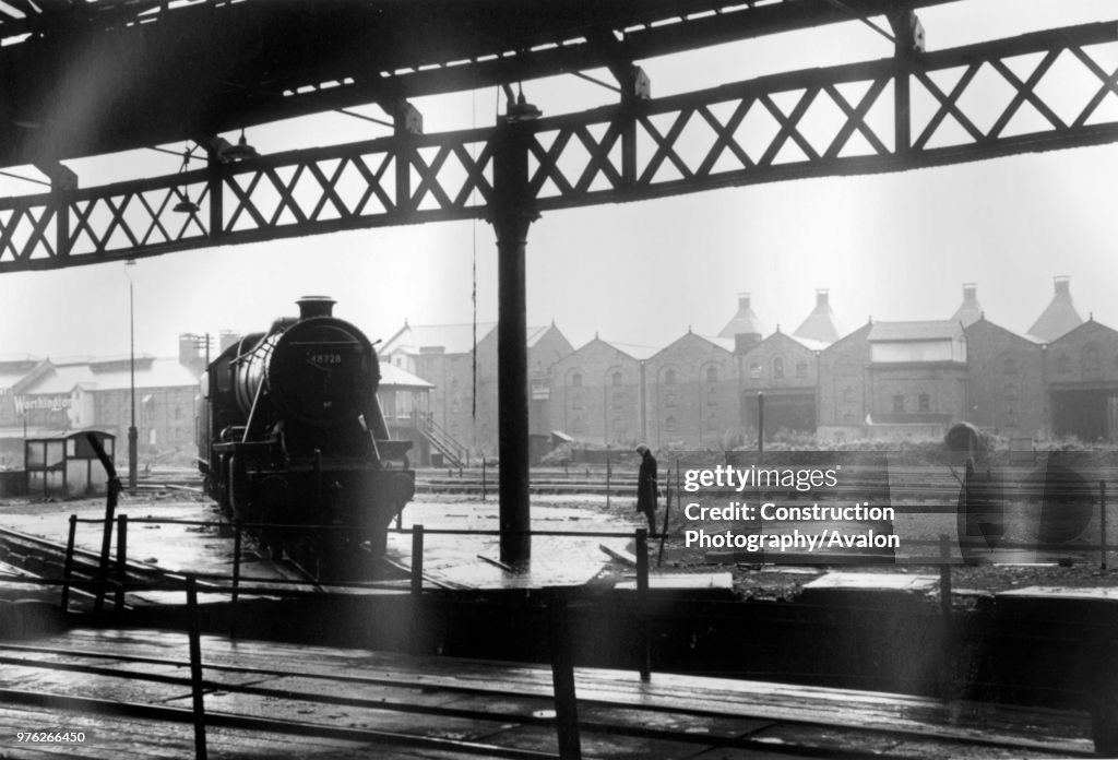 A wet Sunday afternoon in the 1960s finds a Stanier 8F 2-8-0 residing in the motive power depot at Burton On Trent.
