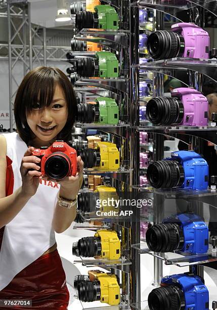 Representative of Japan's optical maker Hoya displays a colorful single-lens-reflex digital camera "Pentax K-x", available in twenty different...