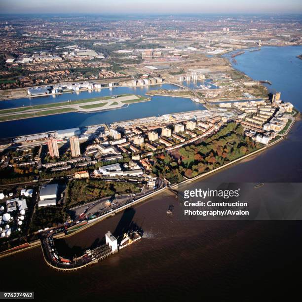Aerial view north east from Thames: Crossrail at ferry terminal, City Airport, Royal Docks Business Park, University of East London, Royal Albert...