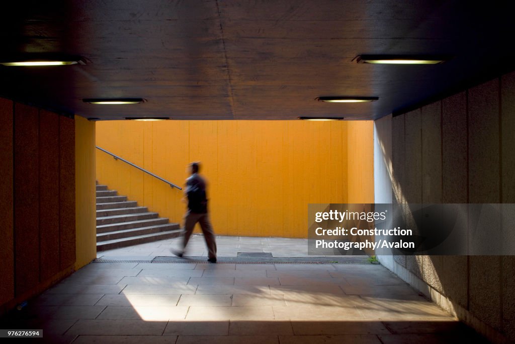 View of underpass and stairwell on London's south bank including blurred figure, UK