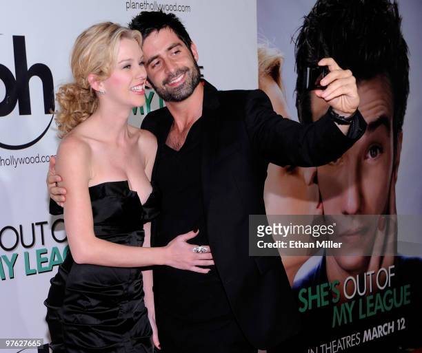 Actress Kim Shaw's boyfriend Stephen Schneider takes a photo of them together as she arrives at the Las Vegas premiere of "She's Out of My League" at...